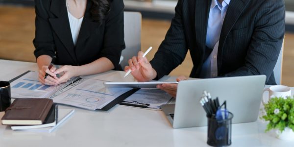 Cropped shot of a businessman in a formal suit at his office discussing a financial contract with his personal professional lawyer.